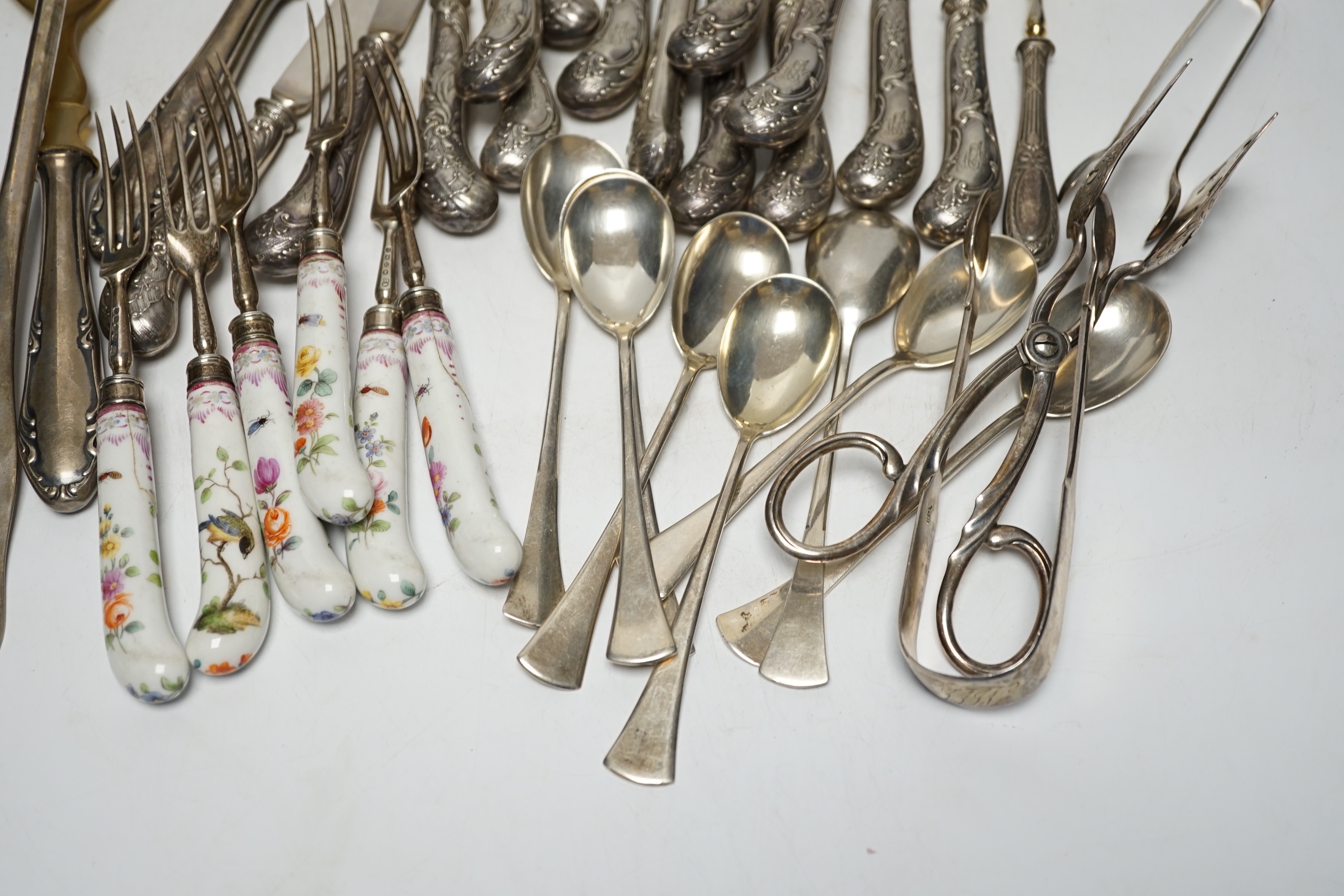 Six Victorian silver dessert forks by George Adams, London, 1880, with Meissen handles, 17.5cm(a.f.), eight 800 standard sorbet spoons, seven pairs of Austro-Hungarian white metal fish eaters, five other continental item